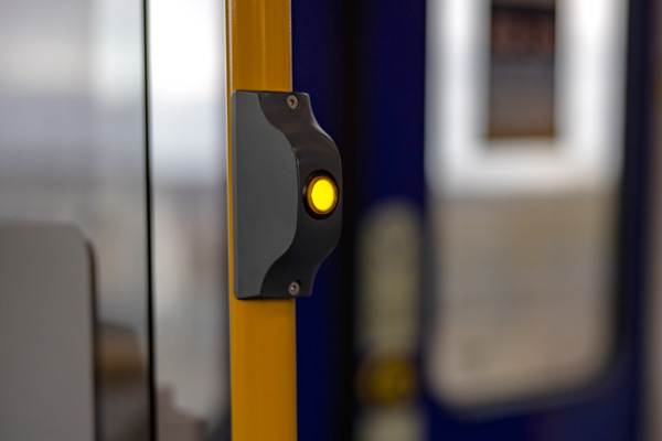 Photo of a pressed tram stop button on board the tram