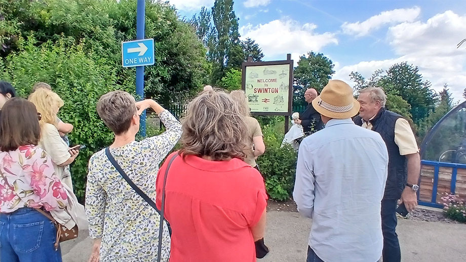Community members unveil the new 'Welcome to Swinton' artwork at Swinton Interchange