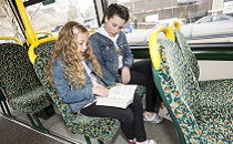 two children talking on a bus