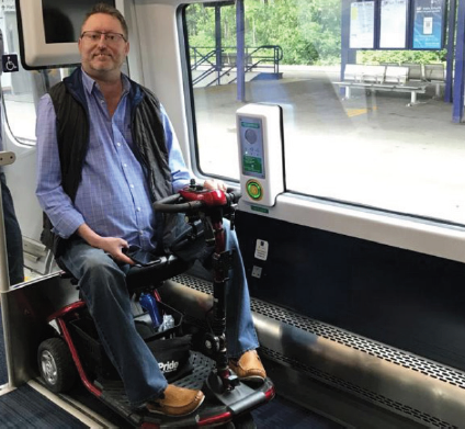 Man on a mobility scooter on a Northern train