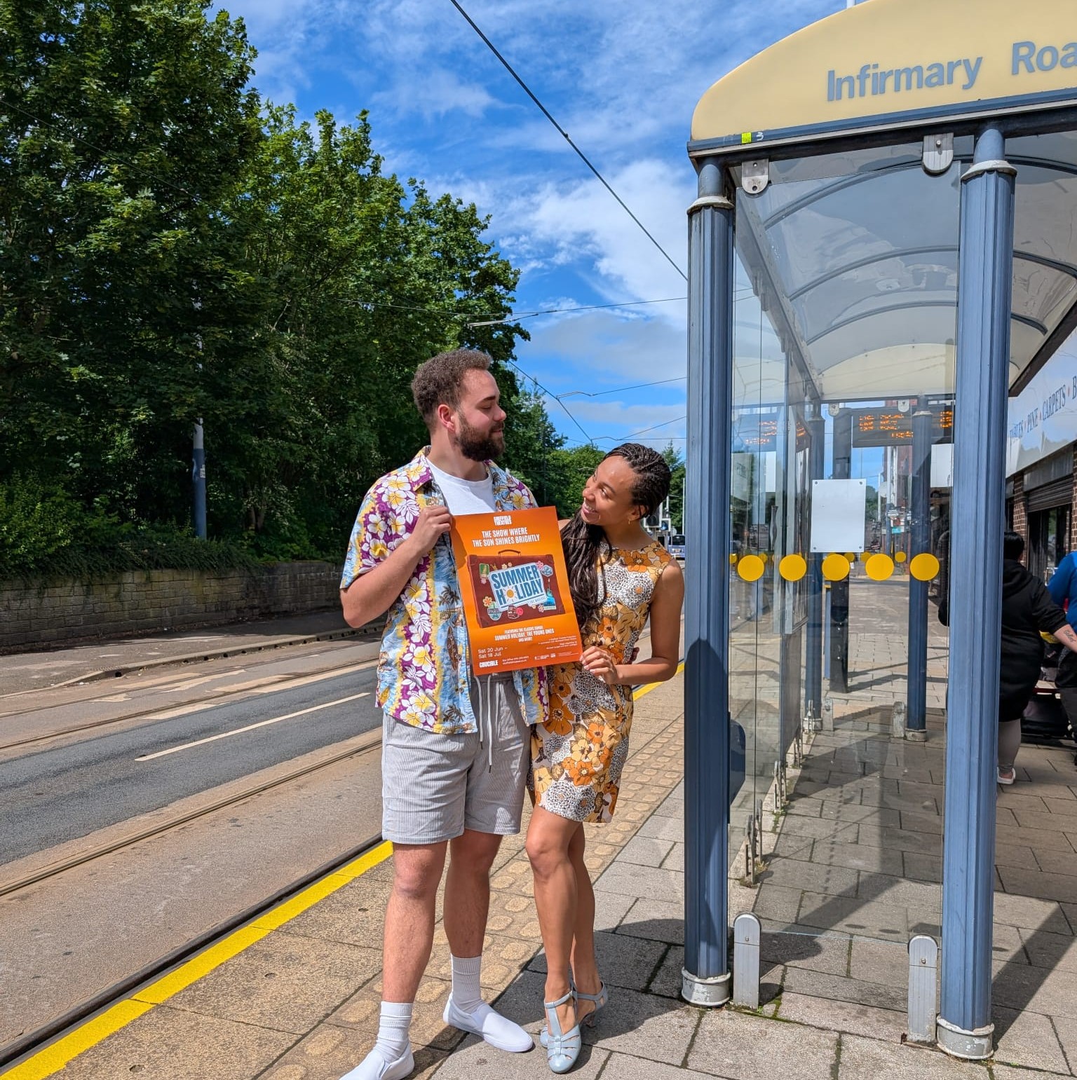 tram stop, holding poster