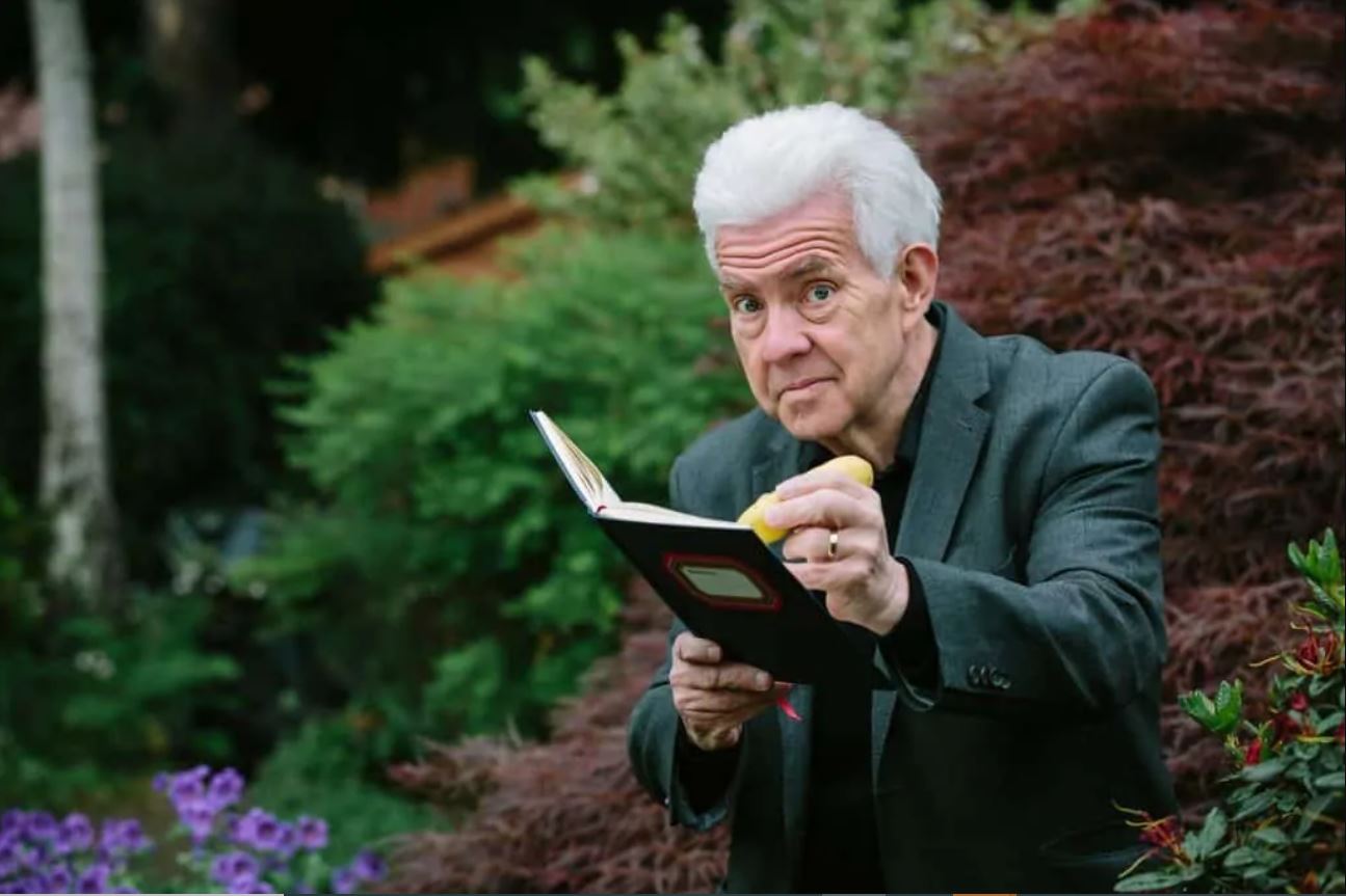 Photo of Ian McMillan with a book