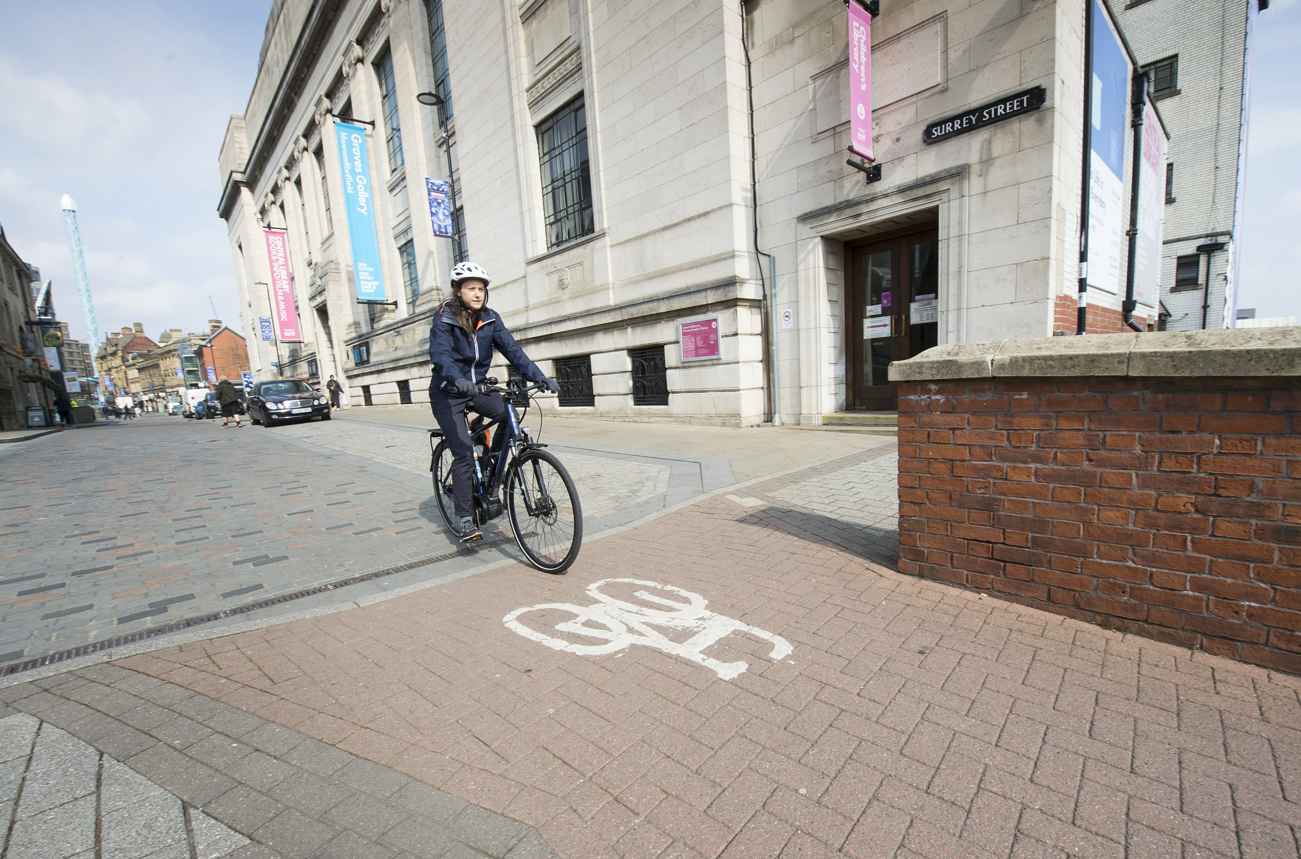 woman cycling through Sheffield street