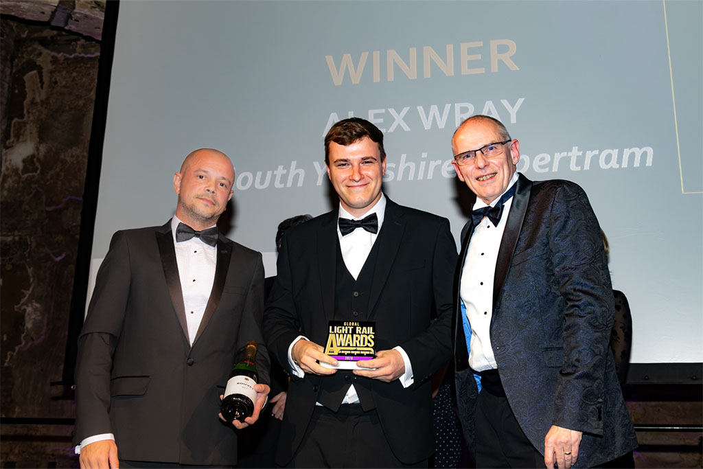 Alex Wray holding award