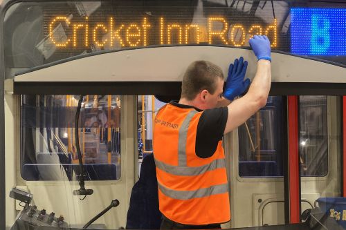 A team polishing and buffing the tram exterior to restore shine and presentation