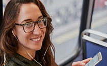 Woman on bus with mobile phone