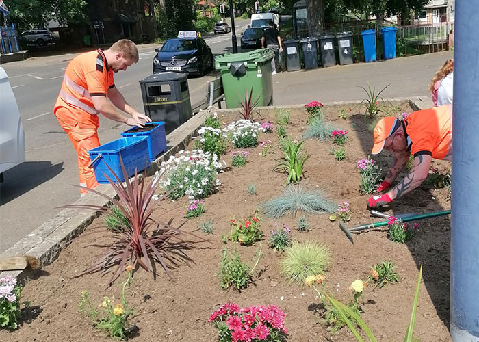 Two volunteers planting flowers at Middlewood