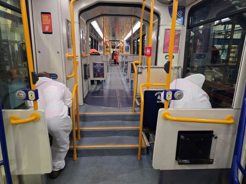 A team of two cleaning while wearing protective gears