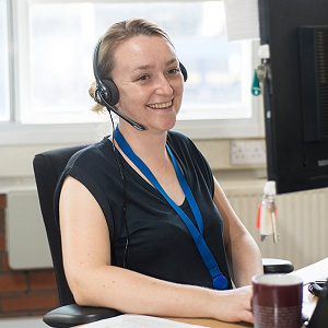 Female call advisor wearing headset smiling on a call