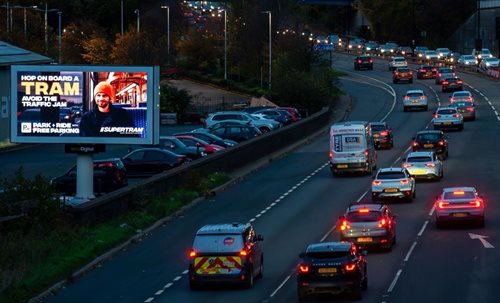 Supertram advert next to busy road