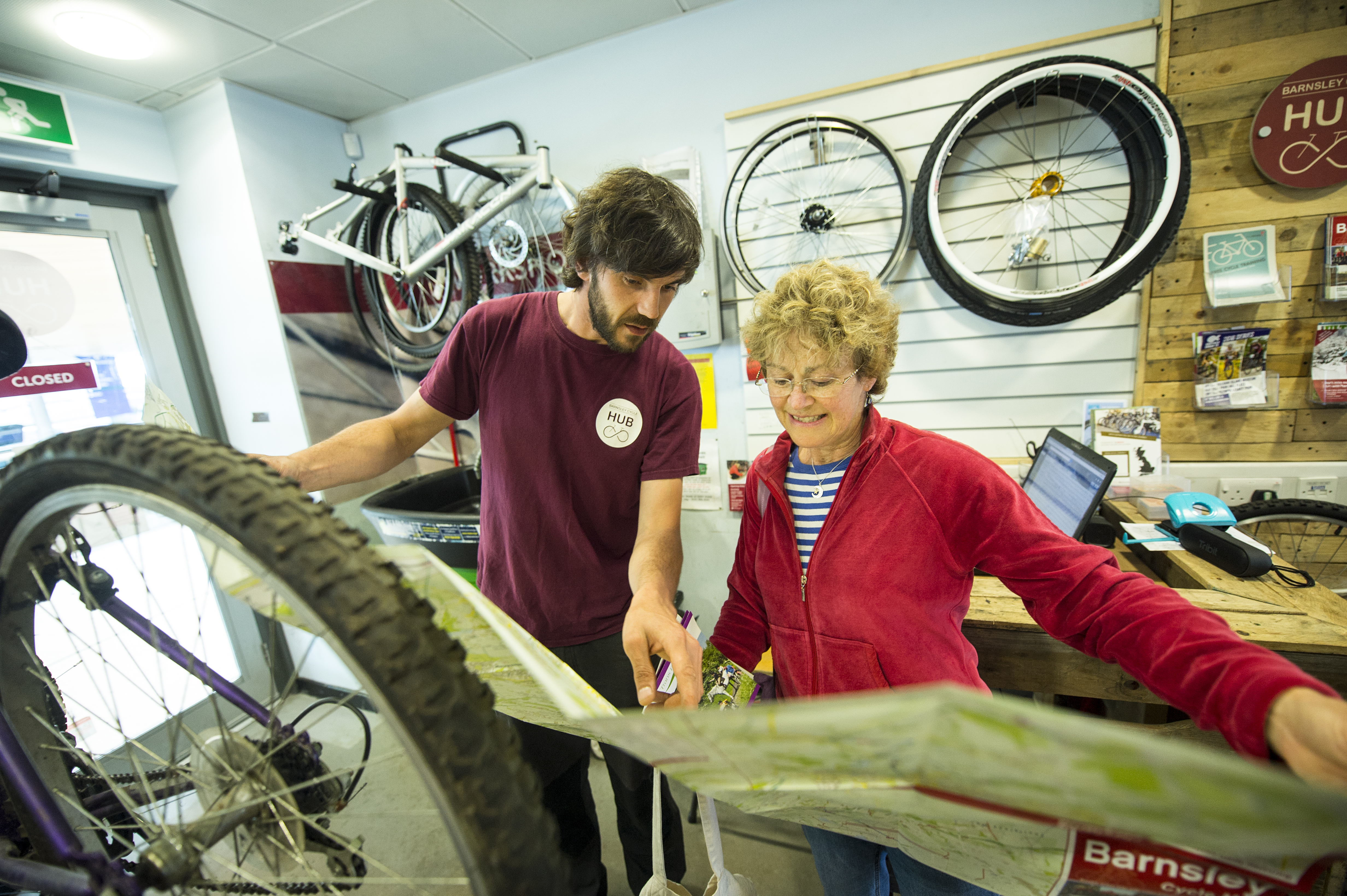 Barnsley Cycle Hub Barnsley Cycle Hub staff looking at map with woman cyclist